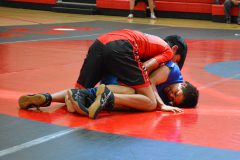 During the Tri-Ute dual wrestling tournament, Nate Hendren fights hard to win a wrestling match against a Ute Tribe wrestler.