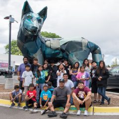 Field trippers and SunUte staff smile for a photo outside of Meow Wolf after experiencing the unique storytelling and interactive house of eternal return.
