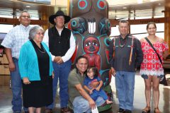 Southern Ute Councilman Cedric J. Chavez, Ute Councilman Shaun Chapoose, carver Douglas James, carver Heather Dawn, Southern Ute Councilwoman Pearl Casias, carver Jewell James and little carver Kayden Nogueira stand next to the Bears Ears Totem Pole after it was presented to the Southern Ute Museum Sunday, July 22. 