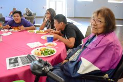 Southern Ute elder, Sanjean Burch smiles for a photo while eating spaghetti with members of the Sunshine Cloud Smith Youth Advisory Council at the Elder’s Celebration Dinner on Monday, August 6.  