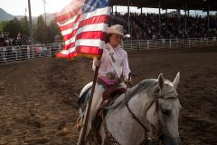 Fiesta Queen, Sydney Cox brings in the American flag during the Fiesta Days Rodeo in Durango, Colo., Saturday, April 28. 