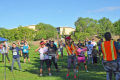 Diabetes Patient Coordinator for Shining Mountain Health & Wellness, Lisa Smith leads the 'Just Move It' group in pre-walk/run exercises and stretches. 