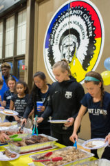 Fort Lewis Soccer players load up their plates with meat from Serious Texas BBQ just after hanging out with SunUte youth athletes at the meet and greet on Tuesday, Oct. 16. 