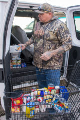 Tyson Thompson places all of his donations for the annual “Fill the Van” food drive that happens outside of Farmers Fresh Market. The Boys and Girls Club and the Public Relations Department of the Southern Ute Indian Tribe will give out all the food that has been donated to families in need.  