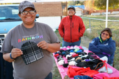 The Nuuciu Baptist Church held a Fall Harvest event in Ignacio on Halloween, Oct. 31. The church gave away cedar firewood, food, jackets, hats and gloves. Kieu Shorty holds one of the many hats she made. Ramona Eagle (right) and Dustine Shorty greet those who came to collect the donations. 
