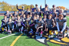 The Bayfield 5th grade Wolverines declare their first place status after defeating the Aztec Tigers, 19-6 in the Youth American Football League (YAFL) Super Bowl, Saturday, Nov. 3 in Bloomfield N.M. Southern Ute tribal members Tavian Box (99) and Andre Thompson (35) join their teammates with the championship trophy after the game.