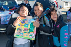 Nailah Simon, Donovan Watts and Patience Watts all pose with their cool new toys given out by BGC staff and Santa during the Boys & Girls Club of the Southern Ute Indian Tribe’s annual Toy Drive giveaway.