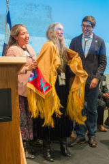 Southern Ute Cultural Preservation NAGPRA Coordinator Cassandra Atencio and her apprentice Garrett Briggs honor Sheila Goff at the opening of the “Written on the Land: Ute Voices, Ute History” exhibit opening with a decorative shawl. Goff was honored for all her devoted work through collaborating with tribes as History Colorado’s Native American Graves Protection and Repatriation Act Liaison and Curator of Archaeology for the past 11 years. 