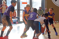 Lakers players scramble for the loose ball against the Raptors in the 8-9-year-old division.

