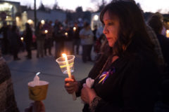 Deidra White Eagle helps to light a candle, honoring her friend’s life. 