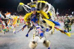 A fancy dancer exhibits his skill during the first night of the Denver March Powwow Grand Entry. 

