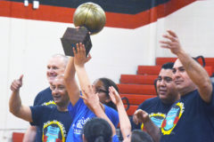 Young Jania Jackson and her Southern Ute Police Department teammates hoist high the Guns ’N’ Hoses Basketball Challenge trophy after SUPD, with help from players repping the Boys & Girls Club of the Southern Ute Indian Tribe, defeated Los Pinos Fire District 41-24 – LPFD had won the previous two clashes – in the 2019 edition Wednesday night, March 20, inside IHS Gymnasium.