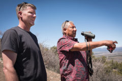 Southern Ute Cultural Coordinator, Hanley Frost (right) and Wildlife Biologist, Aran Johnson keep an eye on the released eagle as it returns home. 