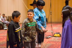 Southern Ute Indian Montessori Academy students: Walter Reynolds, Nate Baker-Valdez and Sinavv Larry line dance together while demonstrating the Bear Dance at the cultural presentation put on by Bear Dance Chief, Matthew Box at the Sky Ute Casino Resort on Monday, May 13. 