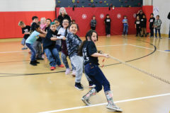 First graders meet each other at the tug-o-war ropes to battle it out on who has the toughest class around.