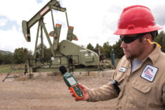 Brian Conner, Environmental Compliance Specialist for Red Willow Production Co. uses a decibel meter to measure sound levels emitted from a nearby pump jack and compressor station, Friday, May 17 on the Southern Ute Reservation. 
