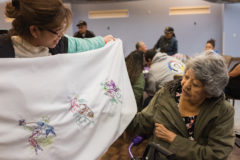 Southern Ute elder, Evalyn Russell admires a piece of embroidery work at the Multi-Purpose Facility, Friday, May 17 during the monthly Sip, Chat and Chew potluck. 