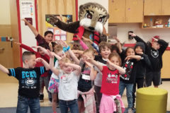 Josh does the dab with Ignacio kindergarten students for Rule #2: Put A Vest on Your Chest. 