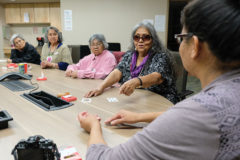 Ute Mountain Ute tribal elder, Betty Howe helps Amy Hammond learn how to play the Monte Card game at the Elders Celebration Dinner. Howe along with Southern Ute tribal elders, Lillian Seibel and Arlene Millich helped teach the young native youth how to play a game they enjoy.