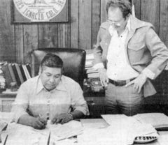 30 years ago, Leonard C. Burch, Southern Ute Tribal Chairman, signs his retirement and health plan with Robert Kennedy looking on. The Southern Ute Tribal Council in their May meeting approved a retirement and health plan for the staff. 