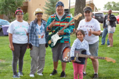 Ready to rock! Lucky winners of the guitar raffles, Kenneth Richards (center) and Adi Rae Rock proudly hold their new guitars, provided by Main Street Music of Aztec, N.M. Ernestine Maez, Ula Gregory and Kasey Correia, sponsored the Rez Rocks Guitar Jam, calling themselves the “Tres Amiga's.”