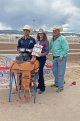 Flanked by CSHSRA Rodeo Queen Ky Murphy at center and CSHSRA President Jack Beach at right, Ignacio's Dustin Sanchez stands at the Moffat County Fairgrounds in Craig, Colo. with prizes befitting Colorado's top high-school bullrider.
