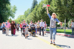 Shining Mountain Health and Wellness’s Registered Dietician Nutritionist, Lisa Smith leads the way at the Breastfeeding Awareness Walk held Thursday, Aug. 15. Participants were chanting breastfeeding anthems as they walked around Tribal Campus. 