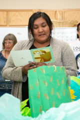 Sunshine Cloud Smith Youth Advisory and Youth Employment Coordinator, Natelle Thompson reads her going away cards and opens gifts from staff at her surprise going away party that was held in the Education Department Building on Friday, August 2. 