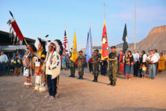 Color Guard are led by Terry Knight, carrying the Eagle Staff, on Saturday evening Grand Entry of the 2019 Ute Mountain Casino Hotel Powwow, Aug. 24 in Towaoc, Colo.