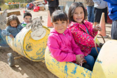 Academy students, Cassie Tahlo and Sakarri Good Tracks giggle as they do use the barrel train together at Sutherland Farms, Friday, Oct. 18.