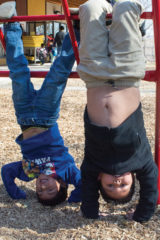 Jayceon Richards and Leandro Litz Jr. hang from the jungle gym while at recess. 