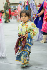 A young jingle dress dancer makes her way around the powwow arena during an intertribal. 