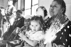 10 years ago: Southern Ute heritage dancers performed November 20, 2009 for children at the Ignacio Elementary School. The presentation, sponsored by Eddie Jr. and Betty Box, was meant to introduce students to Southern Ute Culture. Pictured is Beulah Kent holding her granddaughter, Kaya Bison. 
This photo first appeared in the Dec. 4, 2009, edition of The Southern Ute Drum.