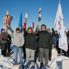 Runners from the Cheyenne and Arapaho tribes of Oklahoma raise their eagle staffs and get the crowd excited for the last leg of the Sand Creek Spiritual Healing Run-Walk on Sunday, Dec 1 at the Riverside Cemetery in Denver. 
