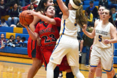 Ignacio’s Ebonee Gomez (23) leans around Dove Creek’s Grace Hatfield (3) for a look at the basket during road action Tuesday, Jan. 7.  The Lady ’Cats earned a 67-41 win in 2A/1A San Juan Basin League play.