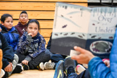 Ayden Baker-Valdez, Keyone Alston and Osias Goodtracks listen intently as Durango Nature Studies Education Director, Mike Bienkowski reads ‘Over and Under’ to the academy students before teaching them about how heat conduction works during the seasons on Thursday, Jan. 16 in the SunUte Community Center Gymnasium. 