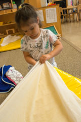 Kellis Wilbourn makes her bed before heading outside to get some sun at the Southern Ute Indian Montessori Academy. 