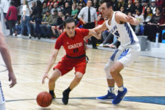 Ignacio’s Triston Thompson (11) tries driving around Mancos’ Connor Showalter (24) and into the lane during SJBL action Tuesday, Feb. 18, at MHS.