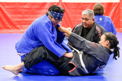 Dimitri Burch stays grounded as his training partner tests him while pulling on his Gi as Gi BJJ, Farrell Dodge give positive reinforcement. 