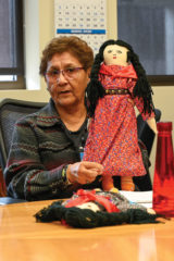 Southern Ute elder, Lynda D’Wolf shows off her Ute dolls during the Ute language class that was held on Friday, Jan. 31. D’Wolf talked about how the Utes used to dress and how the women wore their dresses.