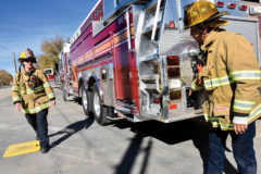 Los Pinos Firefighters, Heather Chesser and Kevin Griego work together to test hoses and perform ladder-training exercises aboard Ladder Truck 81. Aspects of a volunteer training program include a mix of classroom education combined with real world onsite training over an extended period; responsibilities can range from on-site calls to administrative duties. 