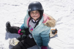 Sakarii Goodtracks finishes a “sledding” run on her snowboard just for fun. 