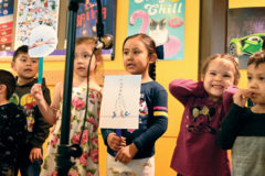 SUIMA student, Olyvia Watts performs a play with her classmates for parents and teachers to watch while attending the annual Book Fair on Thursday, March 12.
