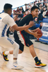 Ignacio sophomore Gabe Tucson (3) looks to pass up the sideline and away from Mancos’ Christian Cova (15) during the 2A-Region IV Tournament championship Saturday, March 7, inside MHS Gymnasium.