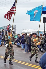 Southern Ute Veterans Association members, Gordon Hammond (U.S. Marines) and Rudley Weaver (U.S. Navy) carry the Southern Ute Tribal flag and the American Flag at the Ira H. Hayes Veterans Social Powwow held, February 21 - 22 in Sacaton, Ariz. The powwow commemorated the 75th anniversary of the flag raising in Iwo Jima, Japan during World War II.  