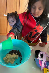 Amonnie Johnson working on his math by baking chocolate chip cookies.  Little sister Zalissa can’t wait to taste them!