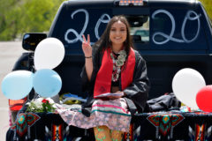 Symbolically flashing a peace sign, Christina Herrera leaves the Ignacio School parking lot for the last time as a Senior Bobcat.