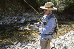 Local fly fishing guide and columnist, Don Oliver, lights a cigar in anticipation of the morning ahead, fishing for trout along Lime Creek — one of his favorite haunts. 