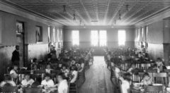 Utes and other Native American students sit at wooden tables in the Southern Ute Agency school’s dining room in Ignacio. The girls sit at one end, the boys at the other. 