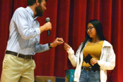 Concluding her first-ever athletic venture, D’Vondra Garcia, right, receives her first athletic letter and accompanying sport-specific pin from head coach Daniel Holley during last year’s end-of-season awards banquet inside IHS Auditorium.  A preseason surgery this year will likely keep the eager junior out of the 2020 cross-country season’s early goings.